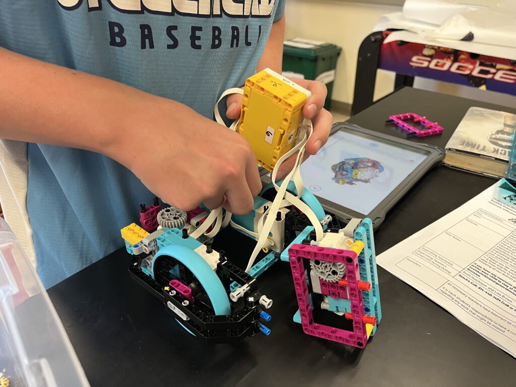 A student works on a LEGO Spike robot