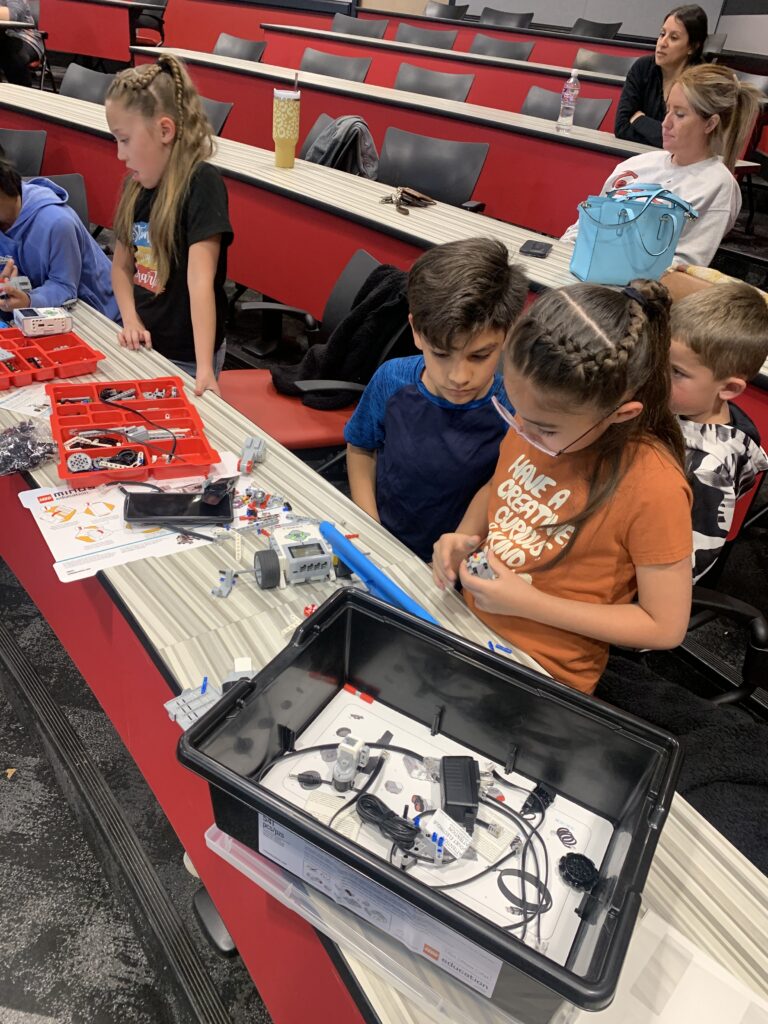 Students work together with an iPad and robot pieces at Texas Tech University. 