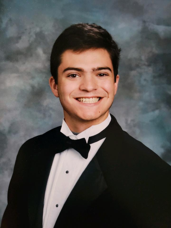 A senior photo of Hunter, smiling in a tuxedo. 