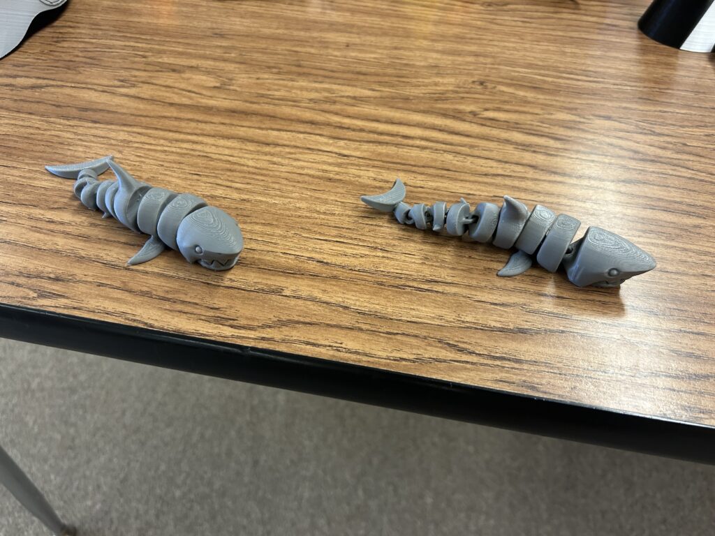 Two 3D printed, segmented sharks created in the middle school makerspace. 