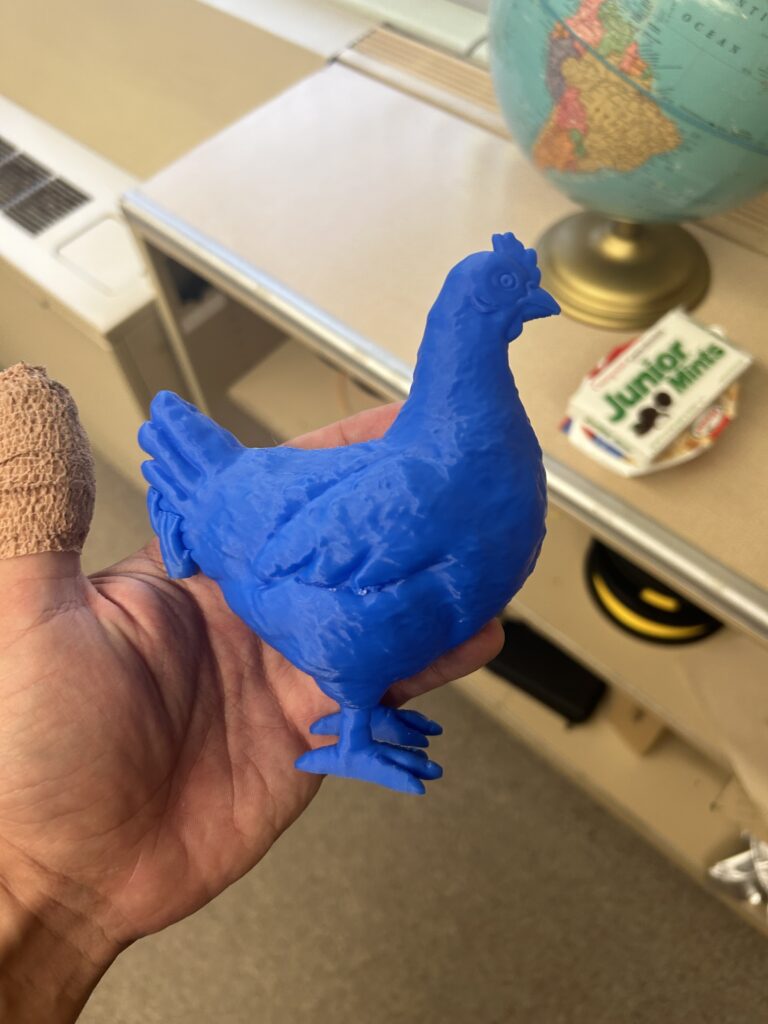 A 3D printed blue chicken figure printed in the makerspace. 