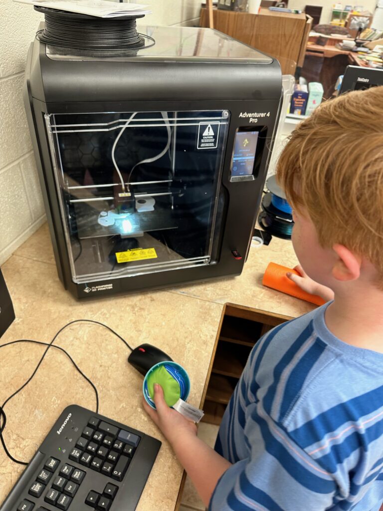 A student printing a GoPro mount on the 3D printer. 