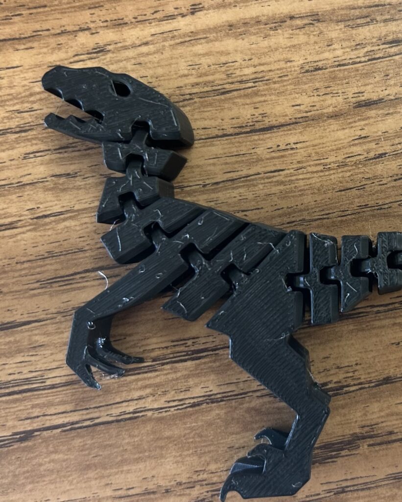 A 3D printed segmented dinosaur made in the middle school makerspace. 