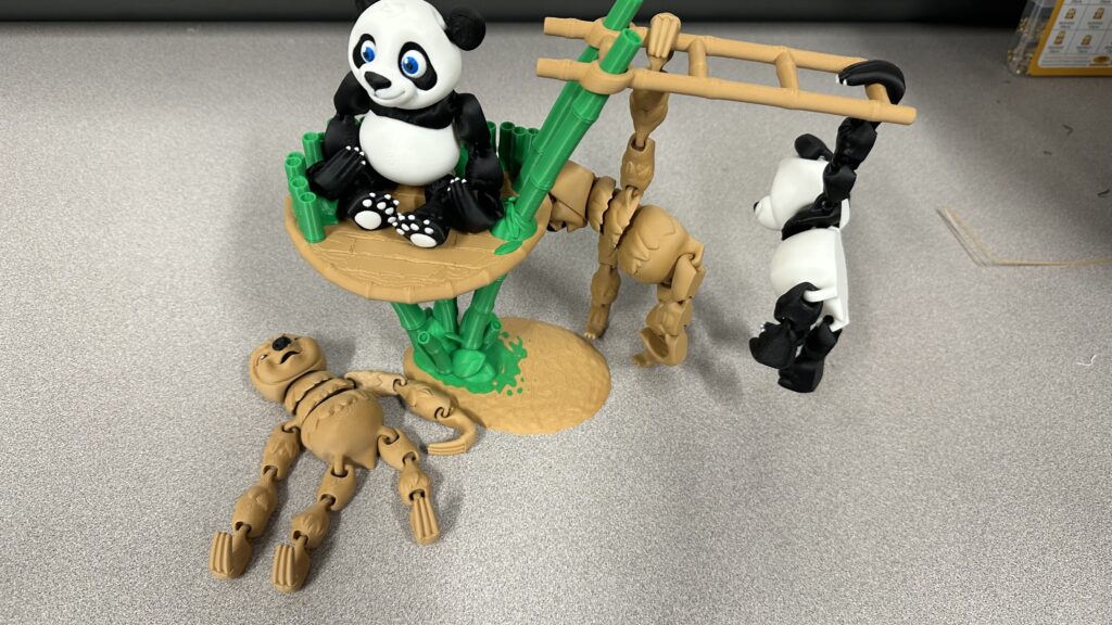 A 3D-printed animal creation, complete with pandas, sloths, bamboo, and a ladder. 