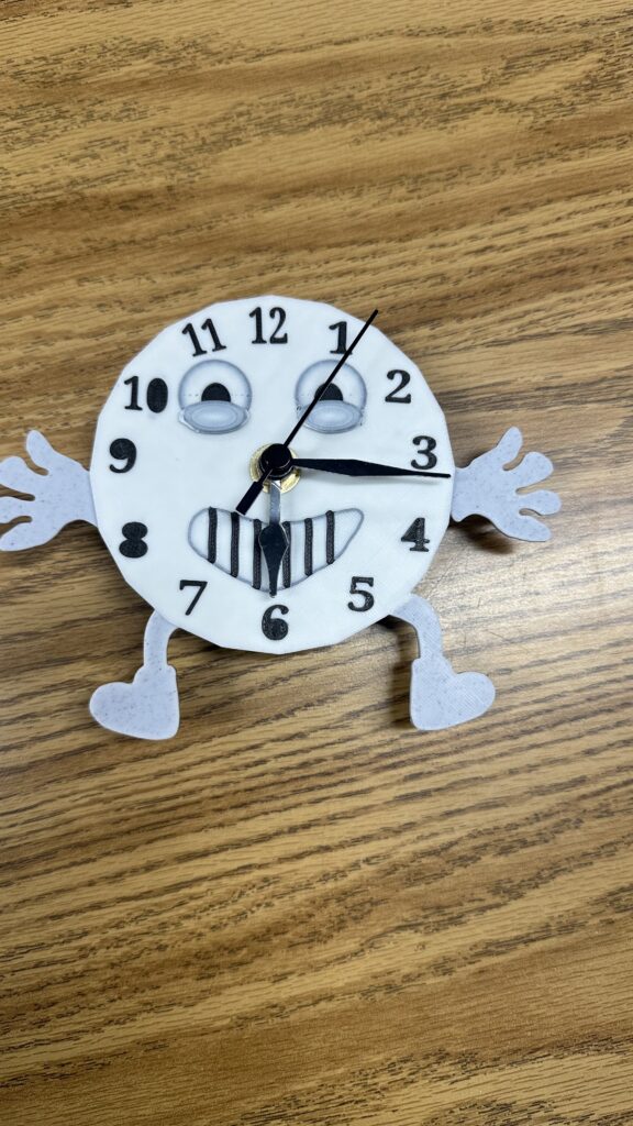 A 3D-printed clock with a smiling face. 