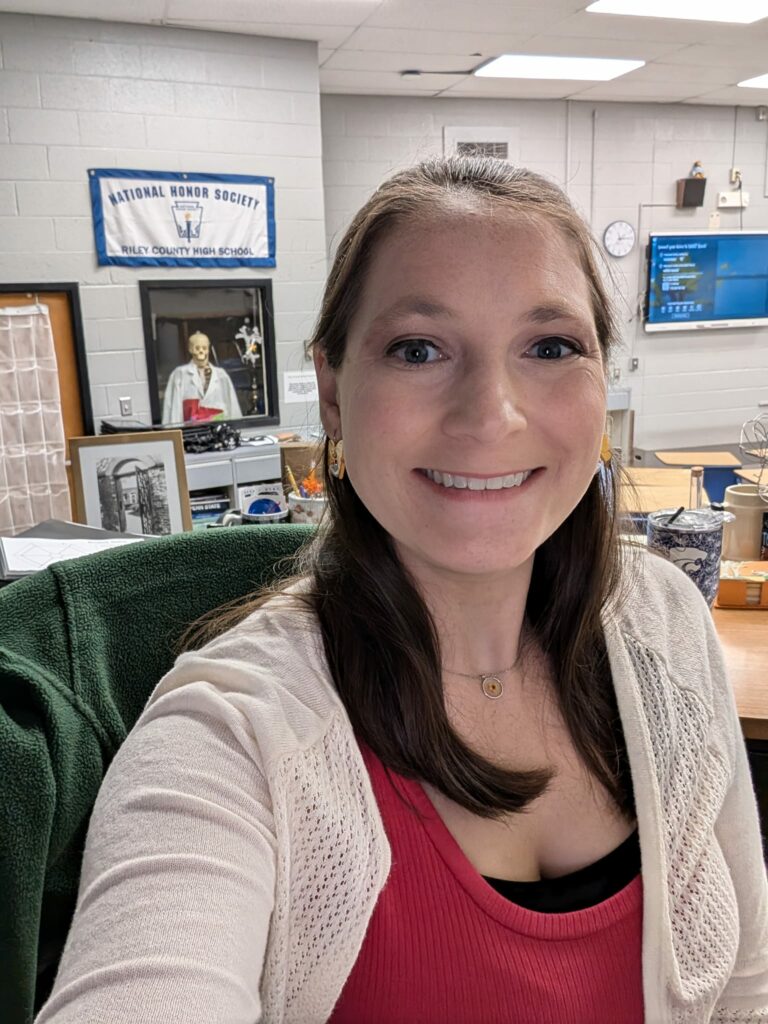 A picture of teacher Breanne Willamson at her classroom desk. 