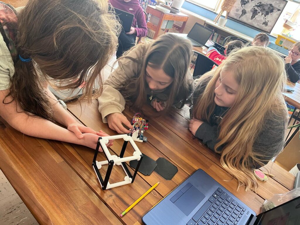 Sarah Enyeart's students work on assembling their CubeSat Emulator. 