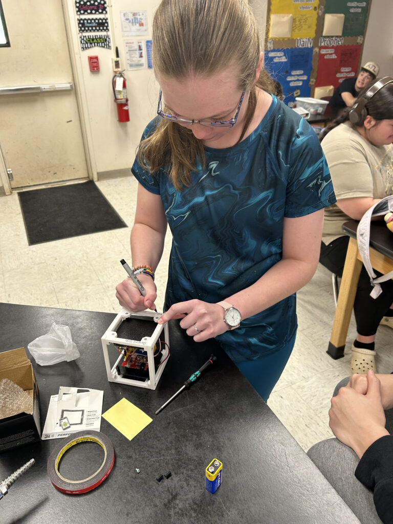Amanda Bramlett's student works on assembling the CubeSat Emulator. 