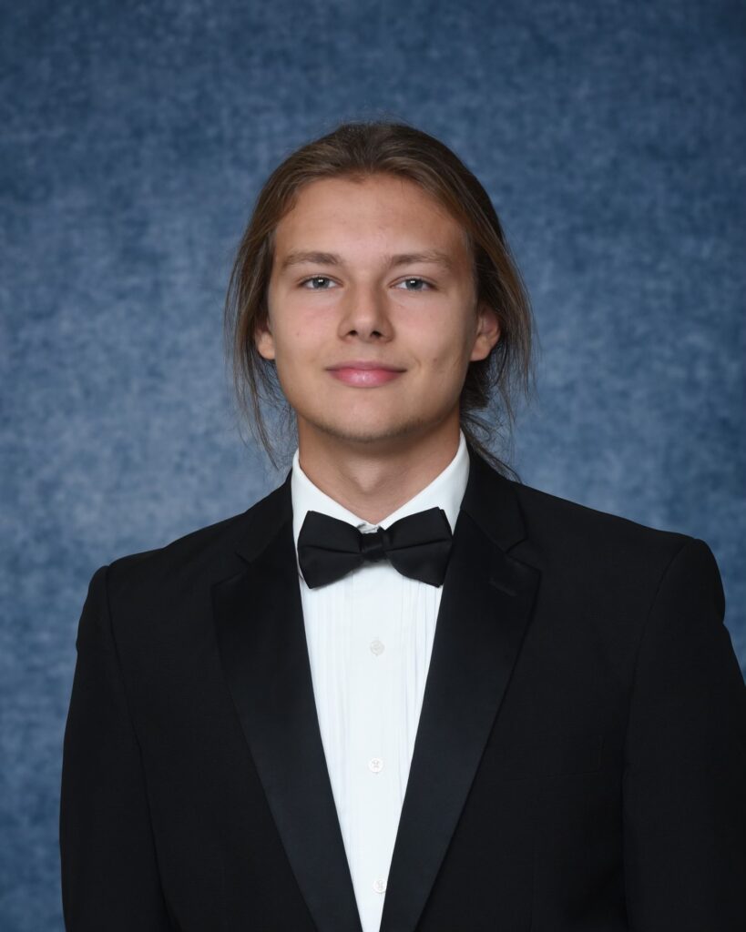 A photo of student Yaroslav Kulyna, smiling in a tux.