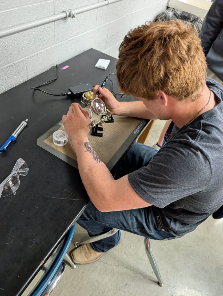 Breanne Williamson's student works on assembling the CubeSat Emulator. 