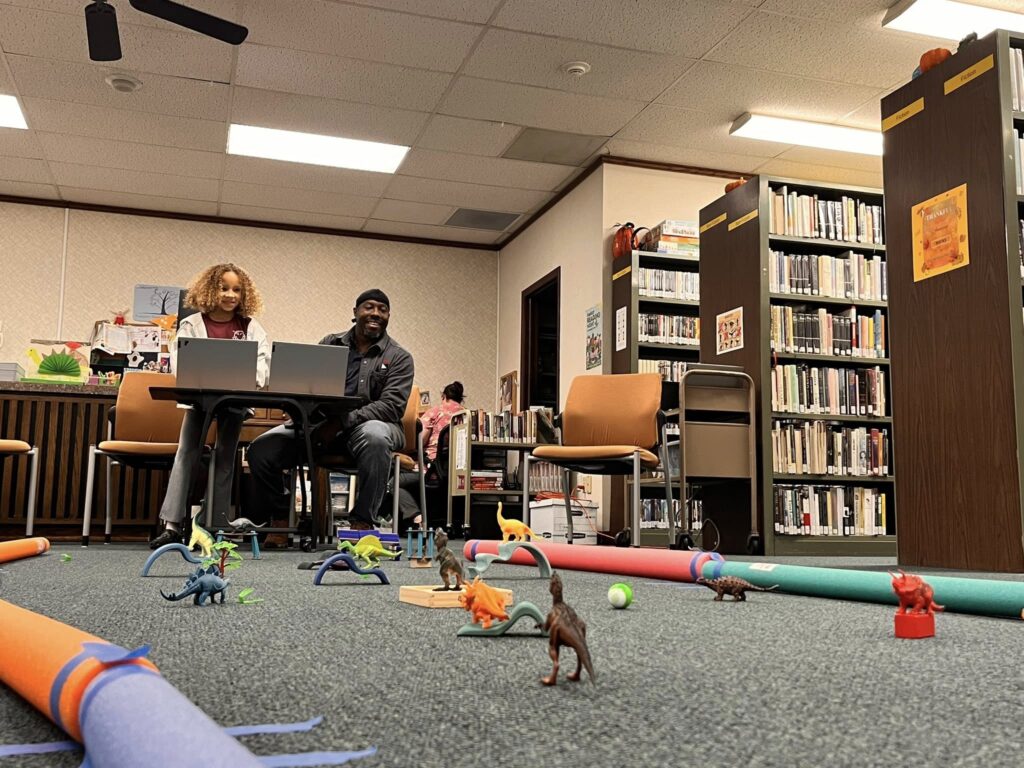 Patrons work on navigating Sphero minis through the Dinovember Maze Challenge.