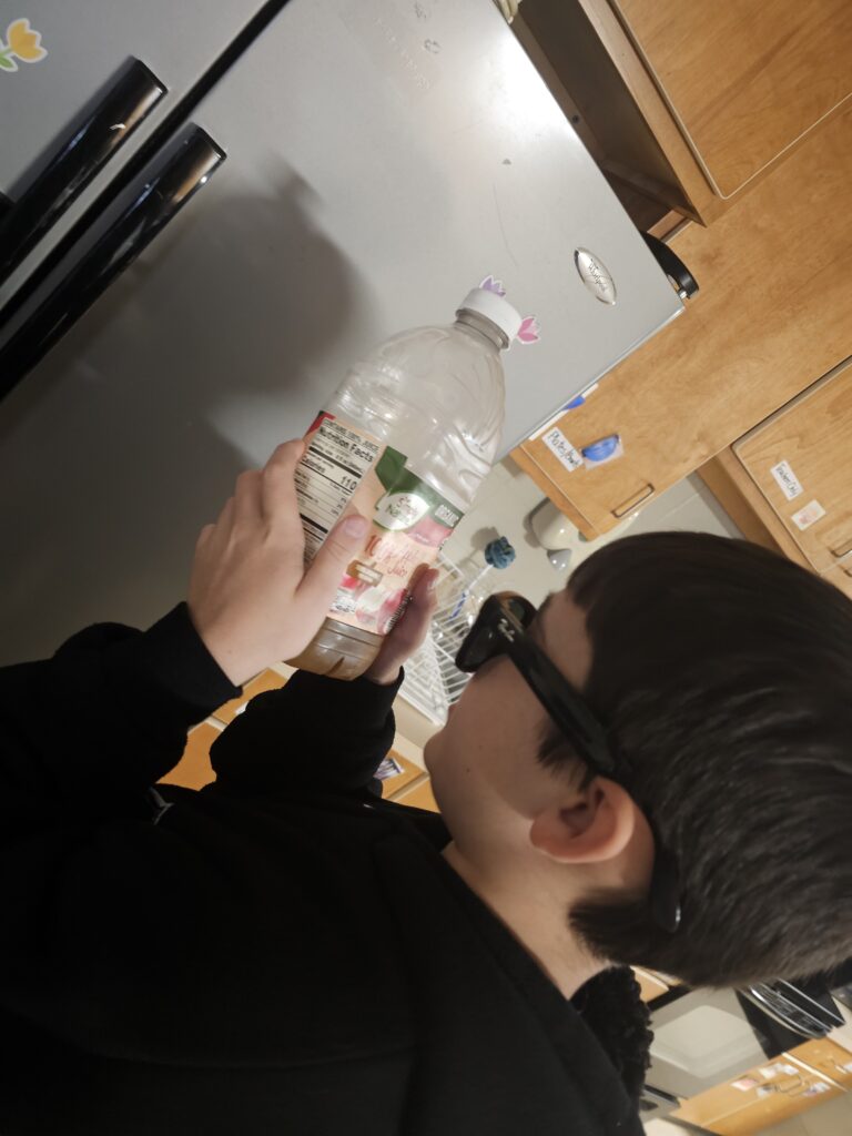 A student reads the label of a drink container with their Meta Glasses. 