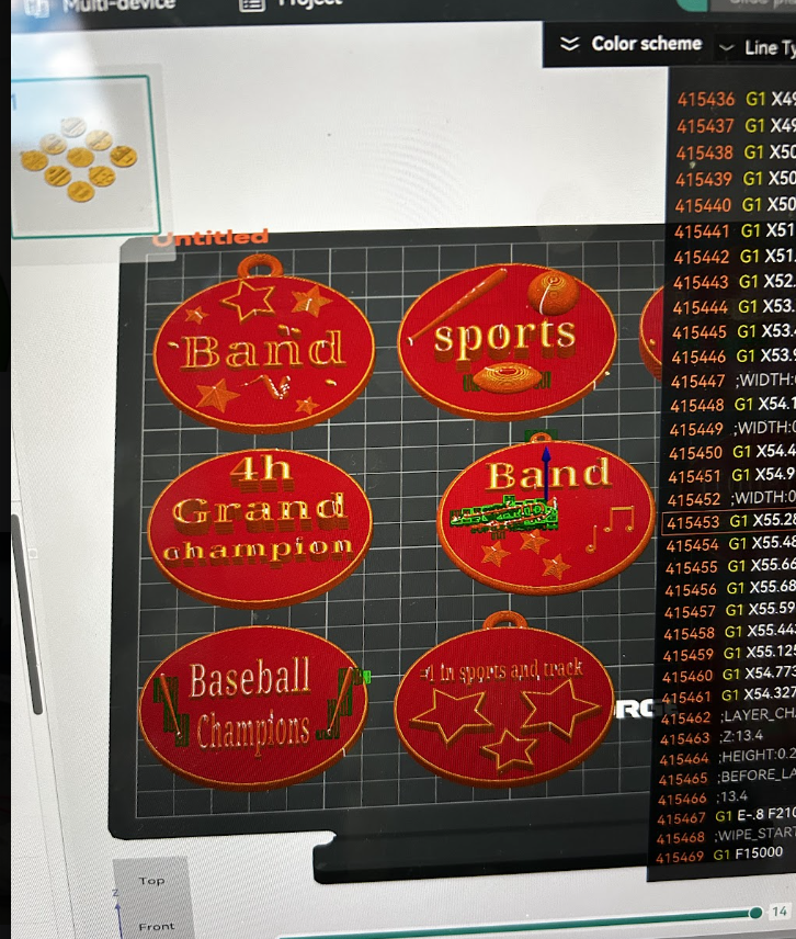 Some of the medals students were designing in TinkedCad. They appear oval and say things like "band", "sports', "4th Grand Champion", and "baseball champion".