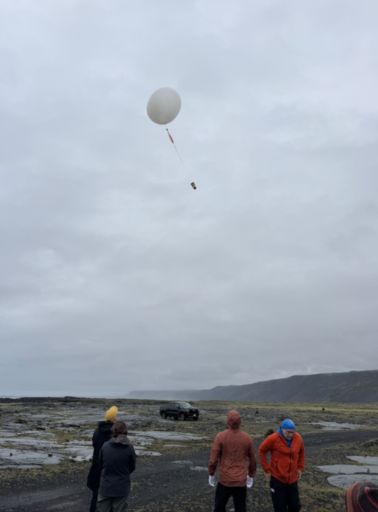 Individuals gather around their high-altitude balloon as they launch their experiments up into the stratosphere.